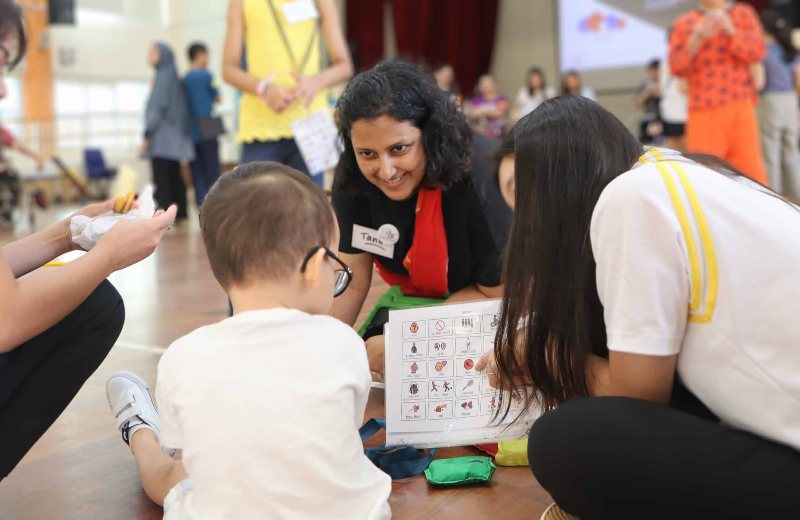 Tanushree communicating with a boy using a communication chart