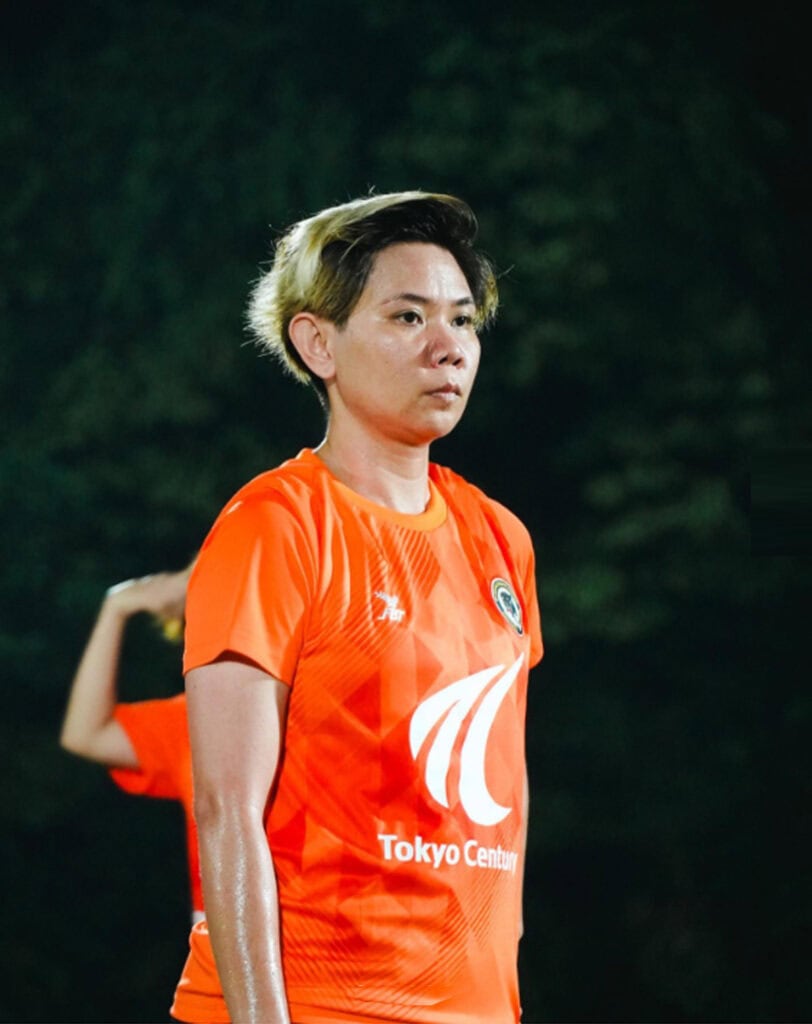 Shahidah in orange jersey looking stoic