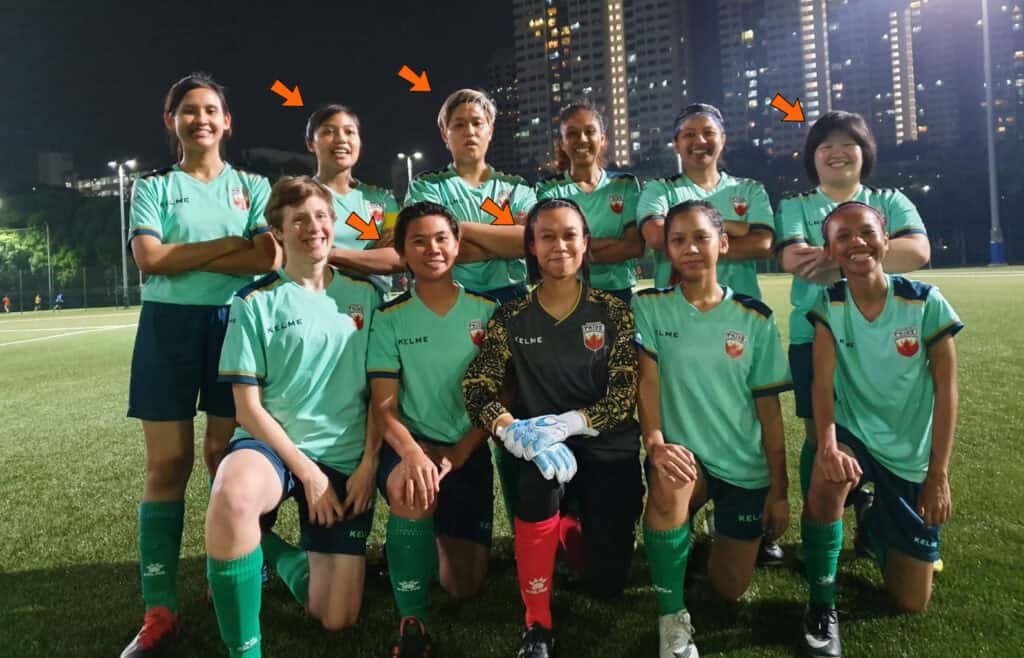 Rena and Shahidah in a team picture of women players in green jerseys