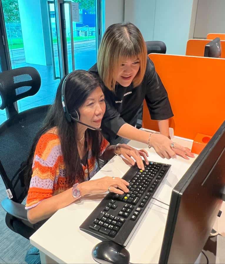 A trainer with an SPD Contact Centre staff