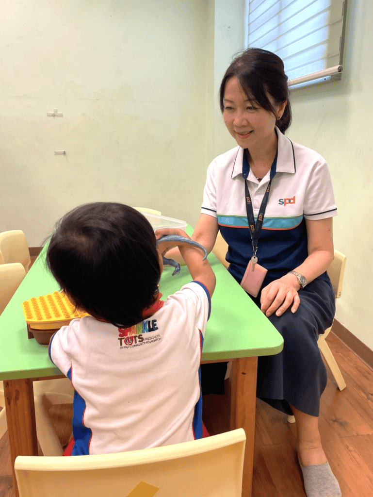 Michelle with a young client at the table