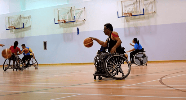 Hussain playing wheelchair basketball