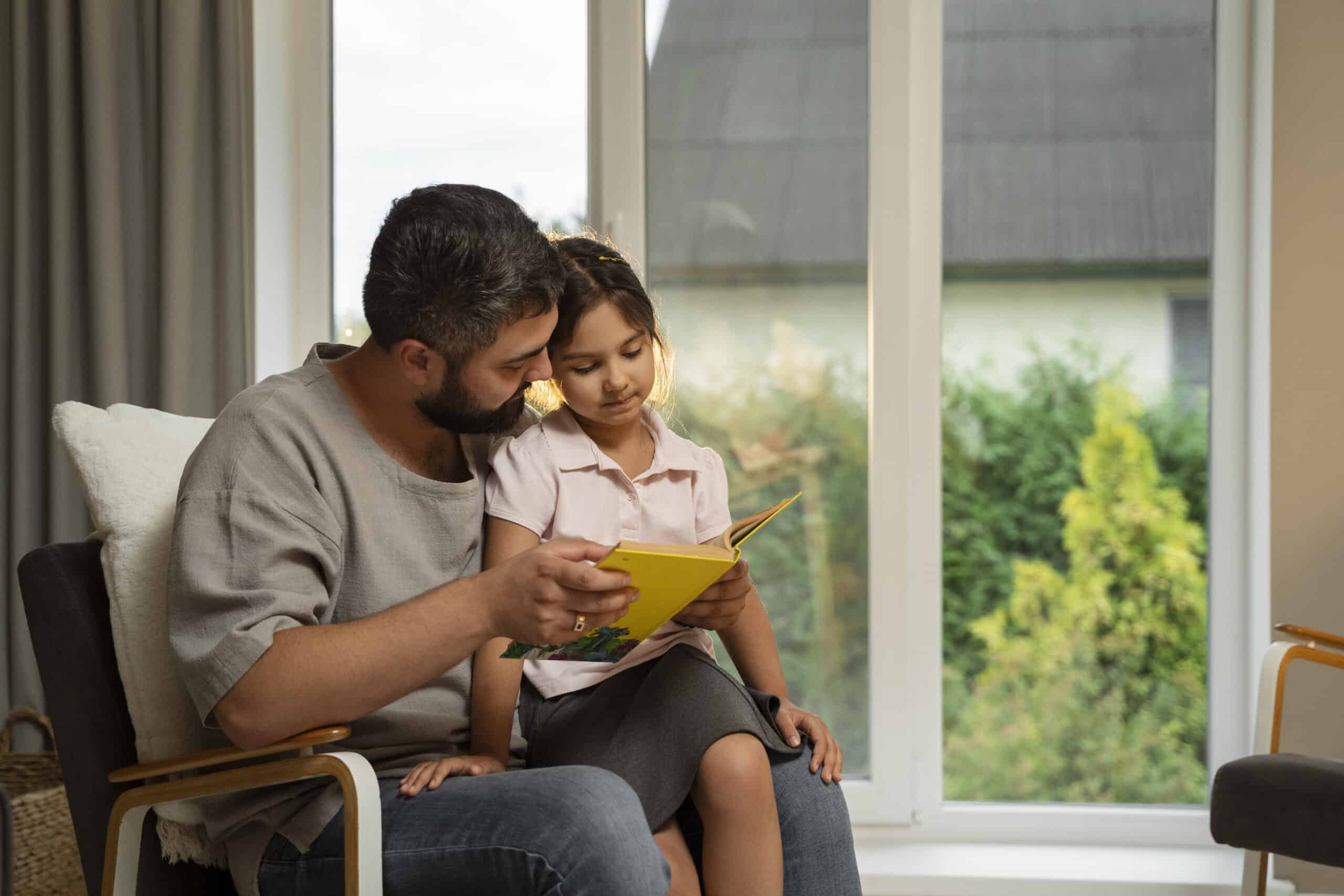 A father reading a book with his daughter