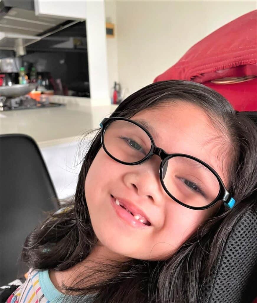 A smiling Syaza in spectacles