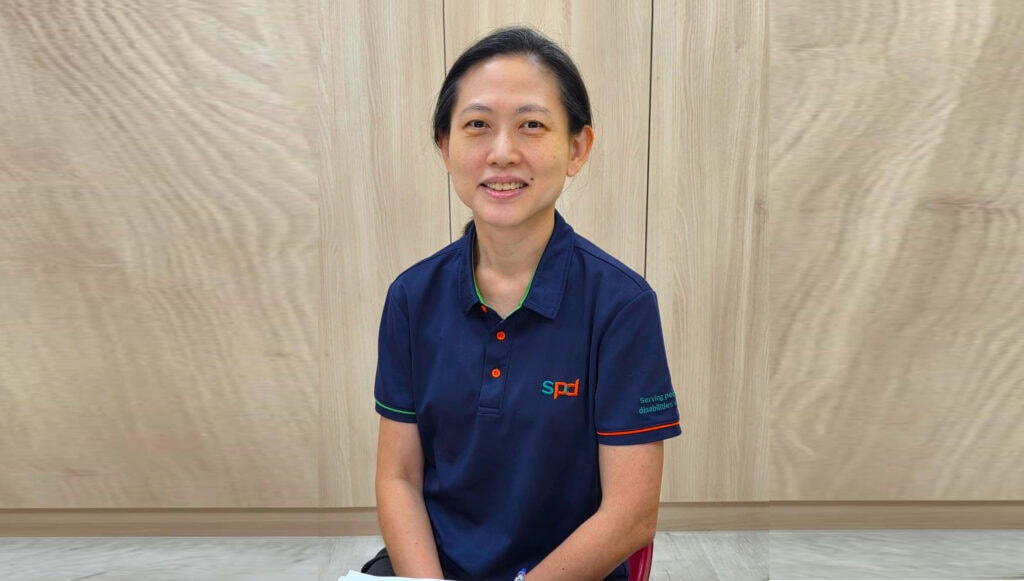 Louisa in S P D uniform seated and smiling