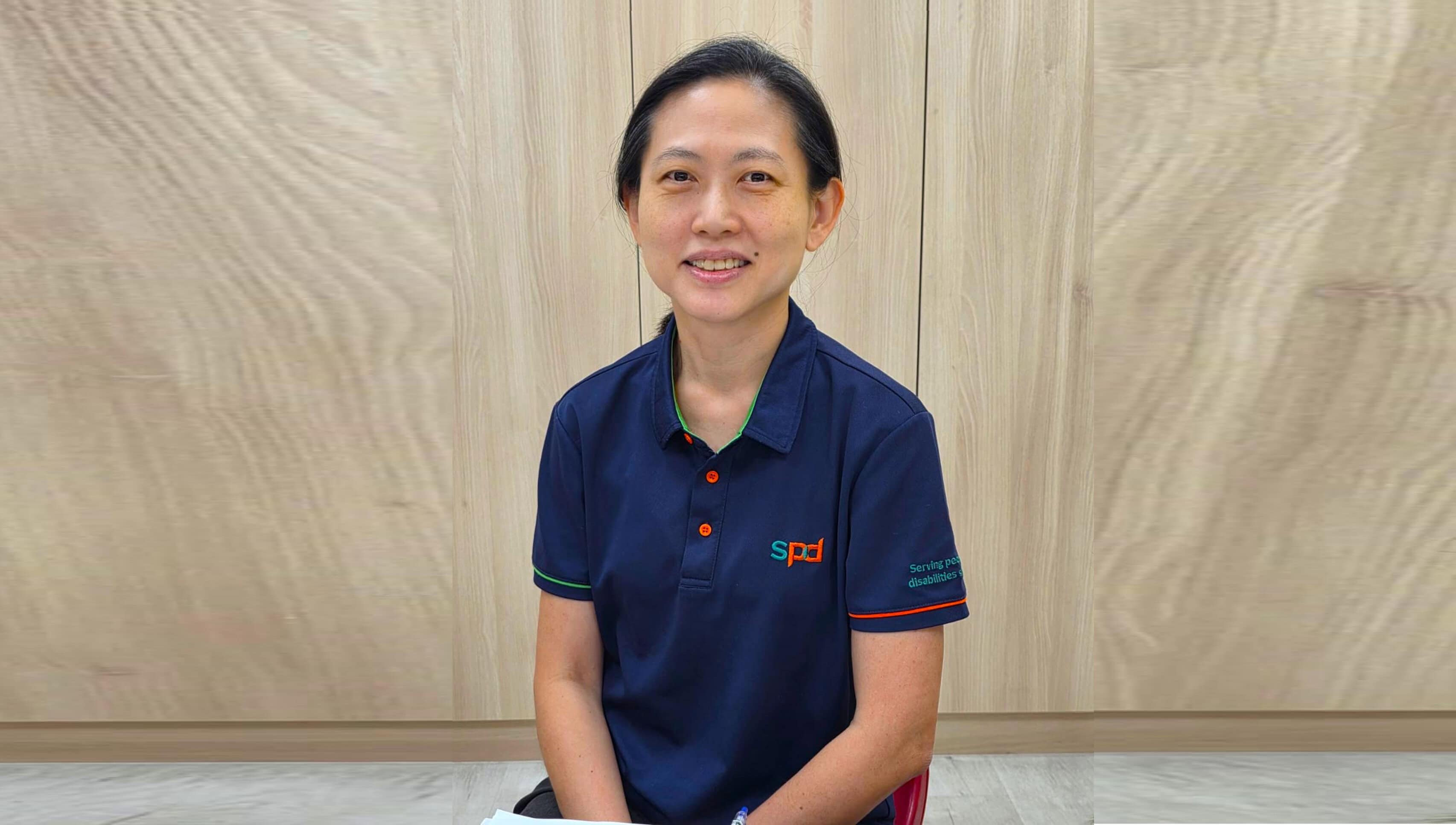 Louisa in S P D uniform seated and smiling