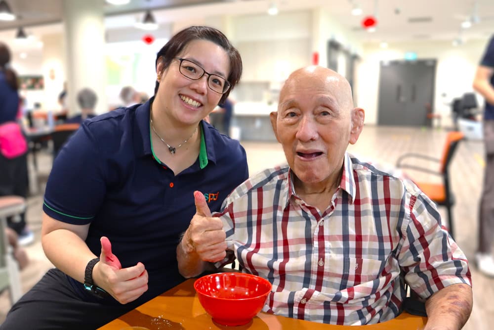Senior Care Centre 1 An occupational therapist and a senior giving their thumbs up