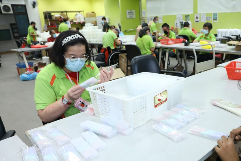 Our Products and Services 3 Trainees packing stationary at the production line