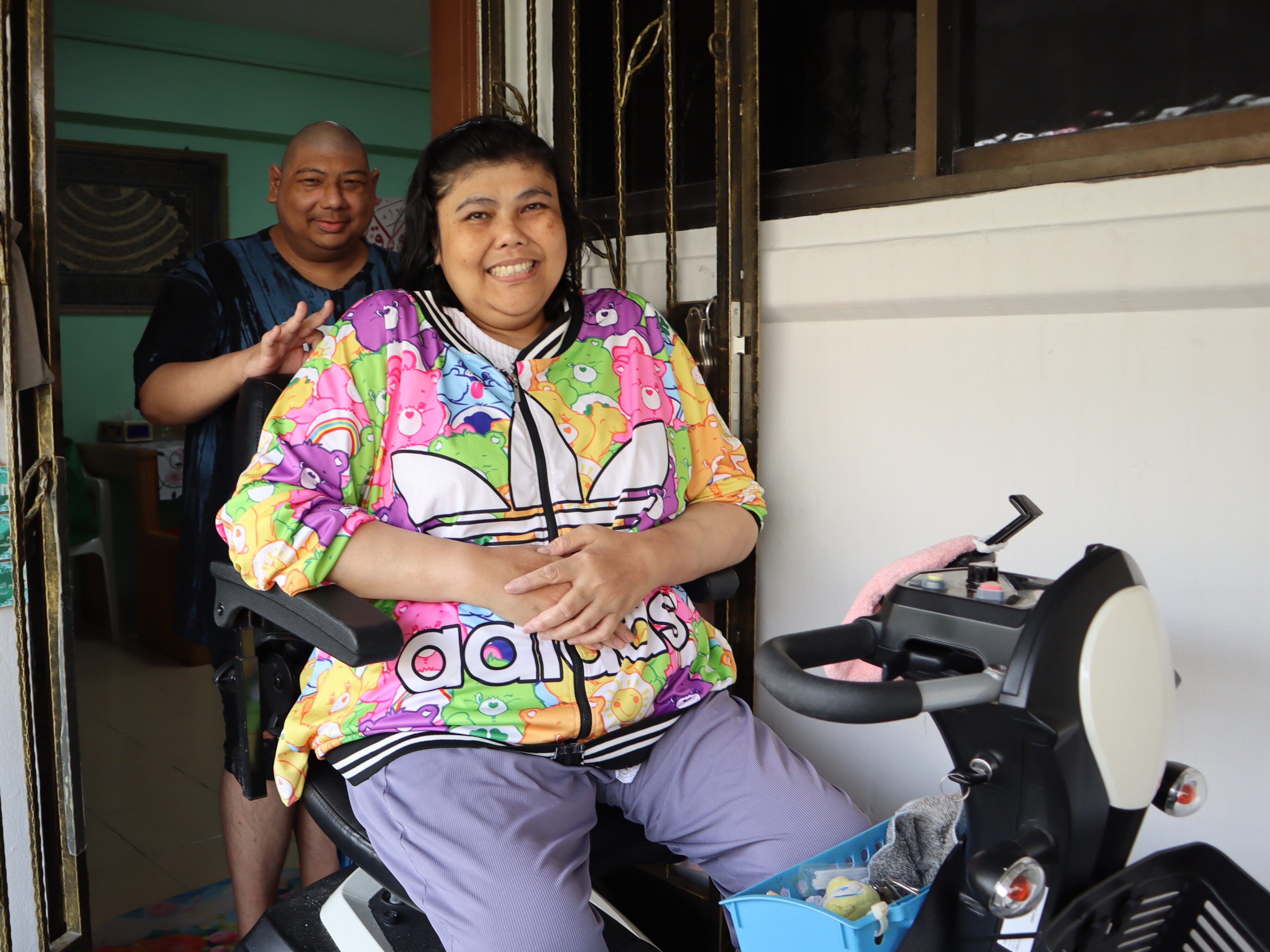 Case Management Support 1 A woman on a mobility scooter, behind her is her brother