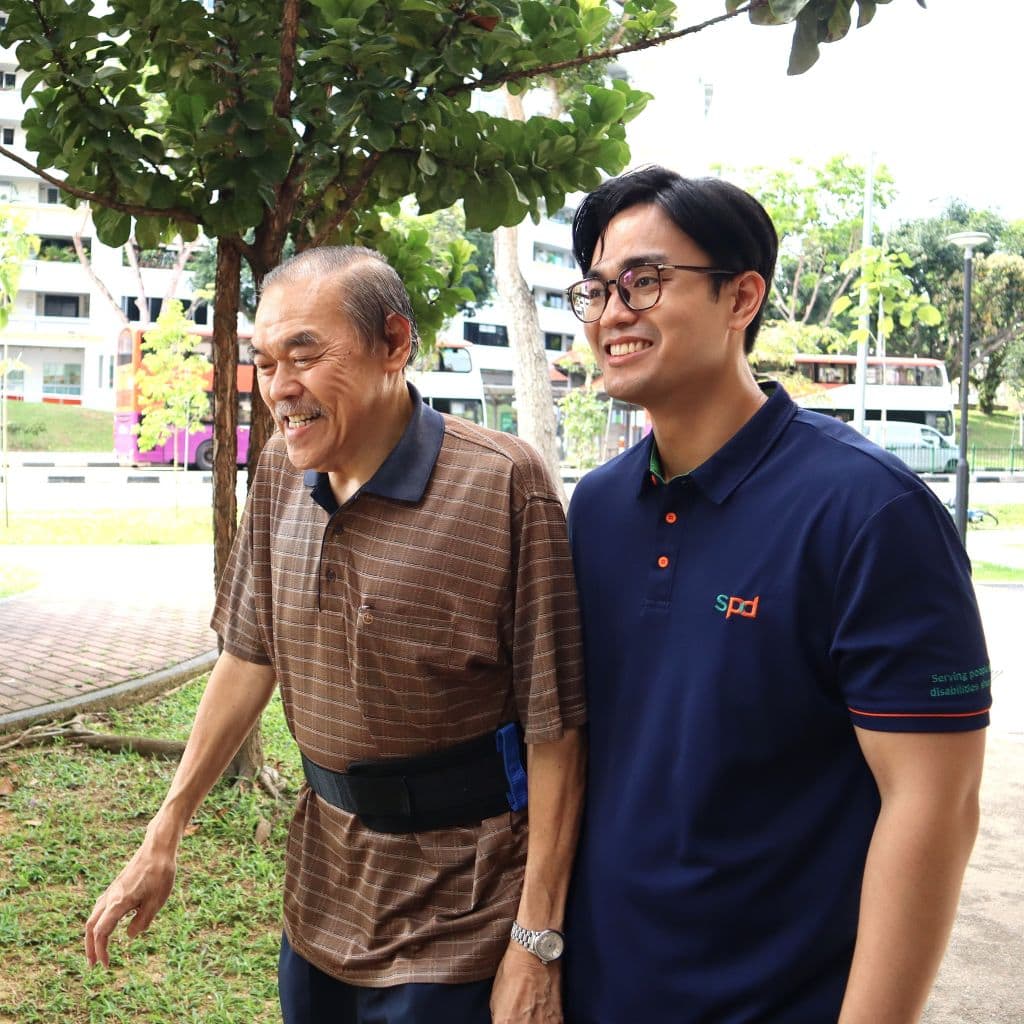 Careers at SPD 1 An S P D physiotherapist walking alongside a senior around a neighbourhood
