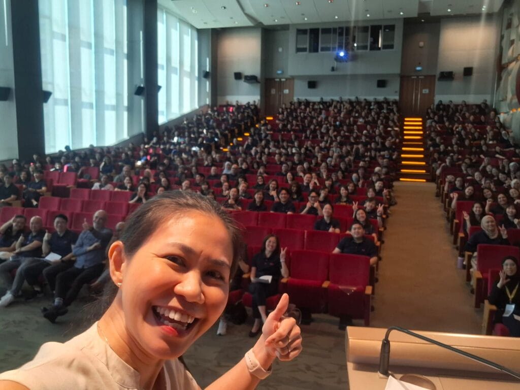 Dr May Lim's selfie with all staff in an auditorium for the S P D Organisational Excellence Day