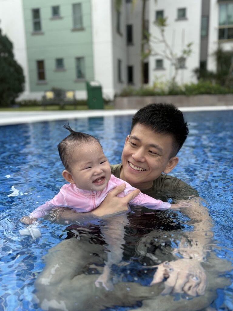 Bradley and daughter smiling in swimming pool