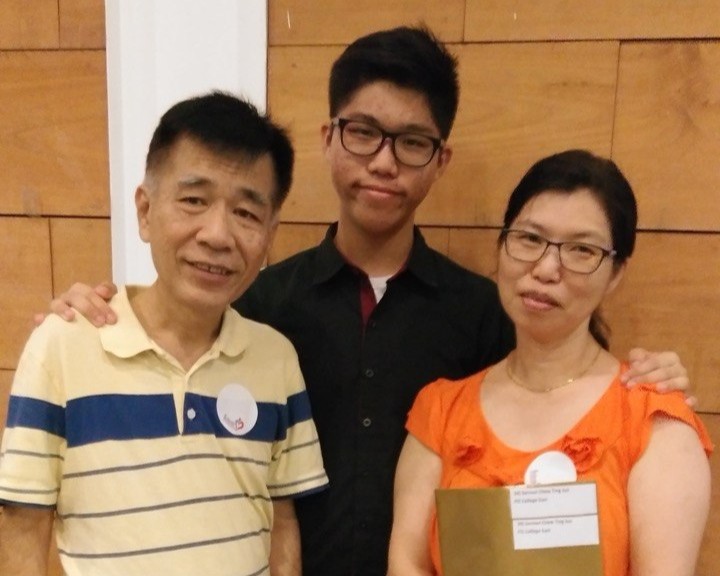 Samuel with his parents during his enrollment into I T E