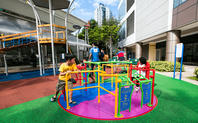 Is your child getting enough physical activity? 4 Children playing a push merry go round at an inclusive playground