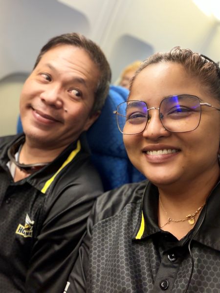 From setback to strength 7 Mr Wong with a happy side eye to Mdm Nooraini on board a flight