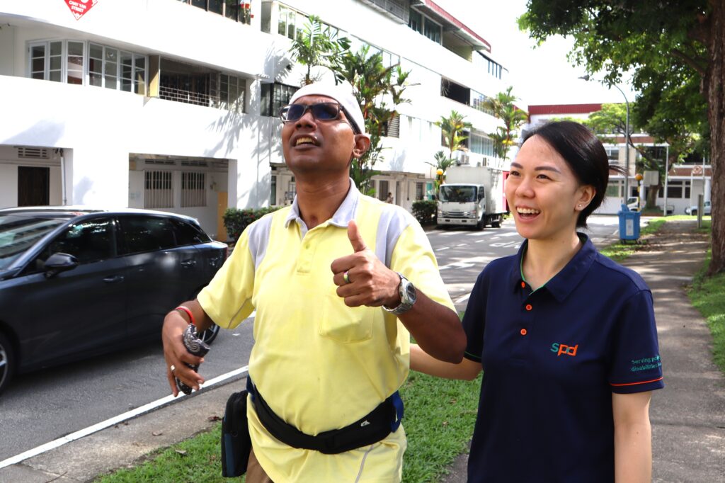 Li Wen guiding an E S L P Living Skills clients on his walk in the community