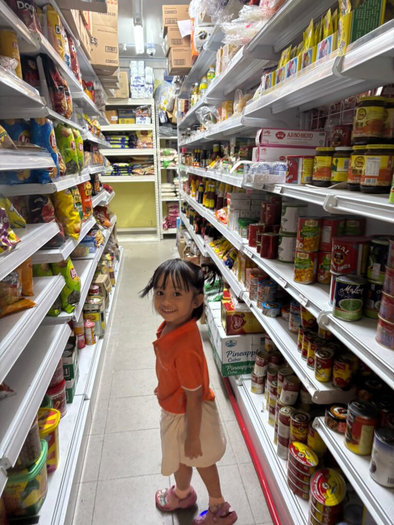 Teachers’ Day Feature: The heart behind every milestone 9 Adelea at the store surrounded by aisles of food products