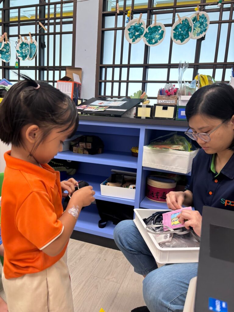 Teachers’ Day Feature: The heart behind every milestone 3 Adelea practises buying snacks with Teacher Vanessa