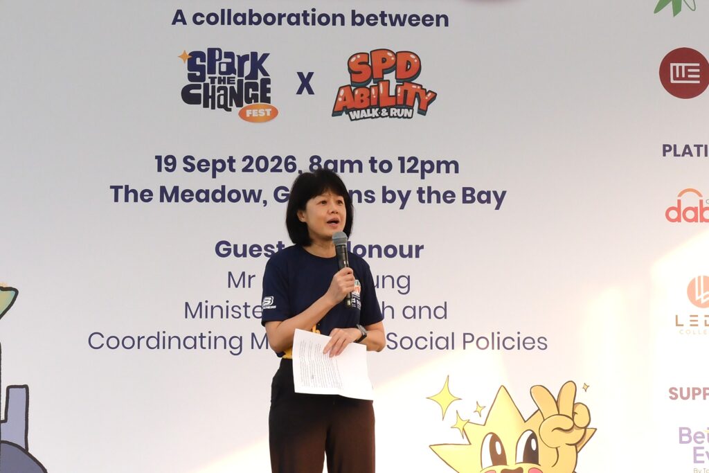 SparkAbility 2026: A Walk for Change – Speech by SPD Chairman Ms Ong Toon Hui 3 Ms Ong giving a speech against the event backdrop
