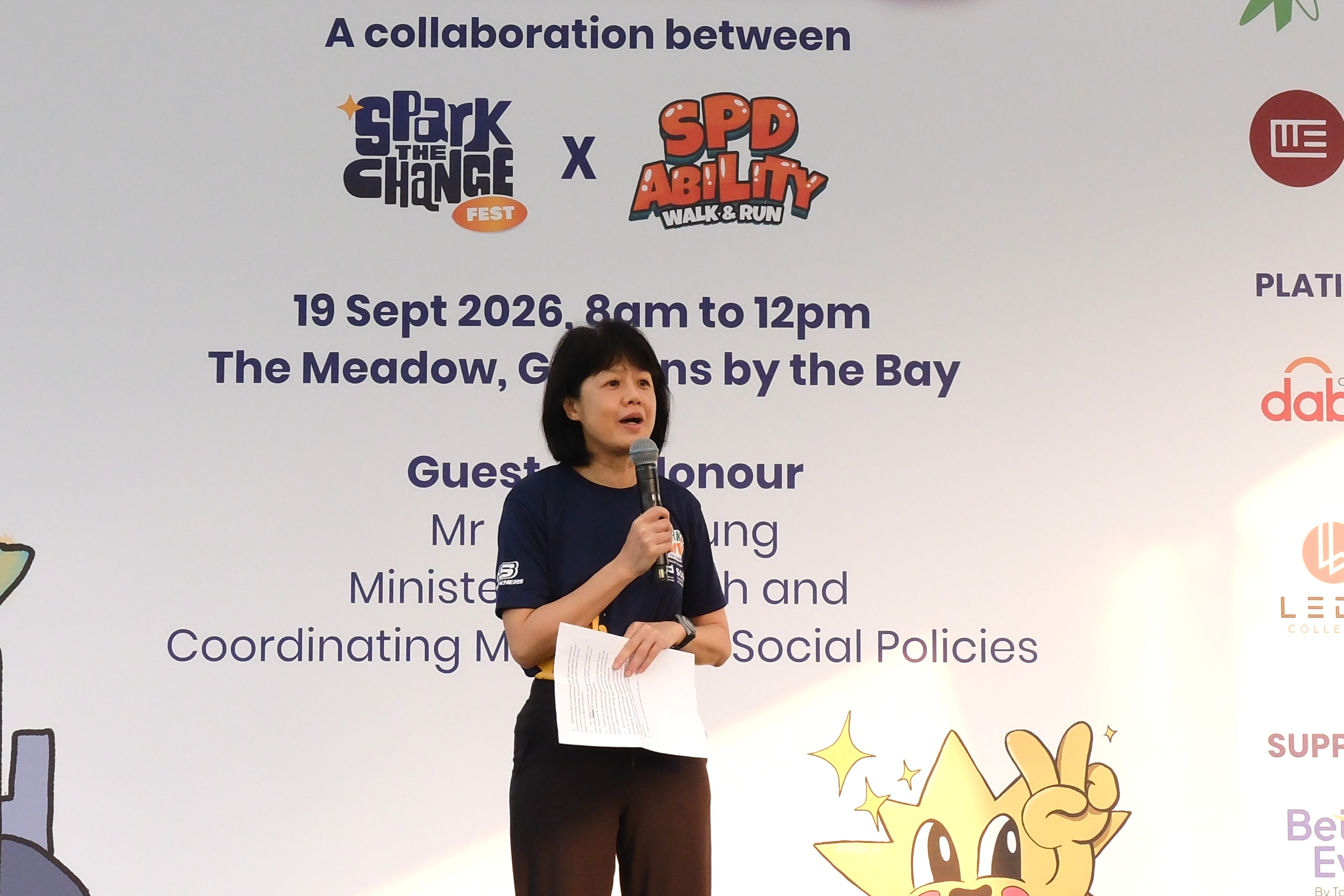 Ms Ong giving a speech against the event backdrop