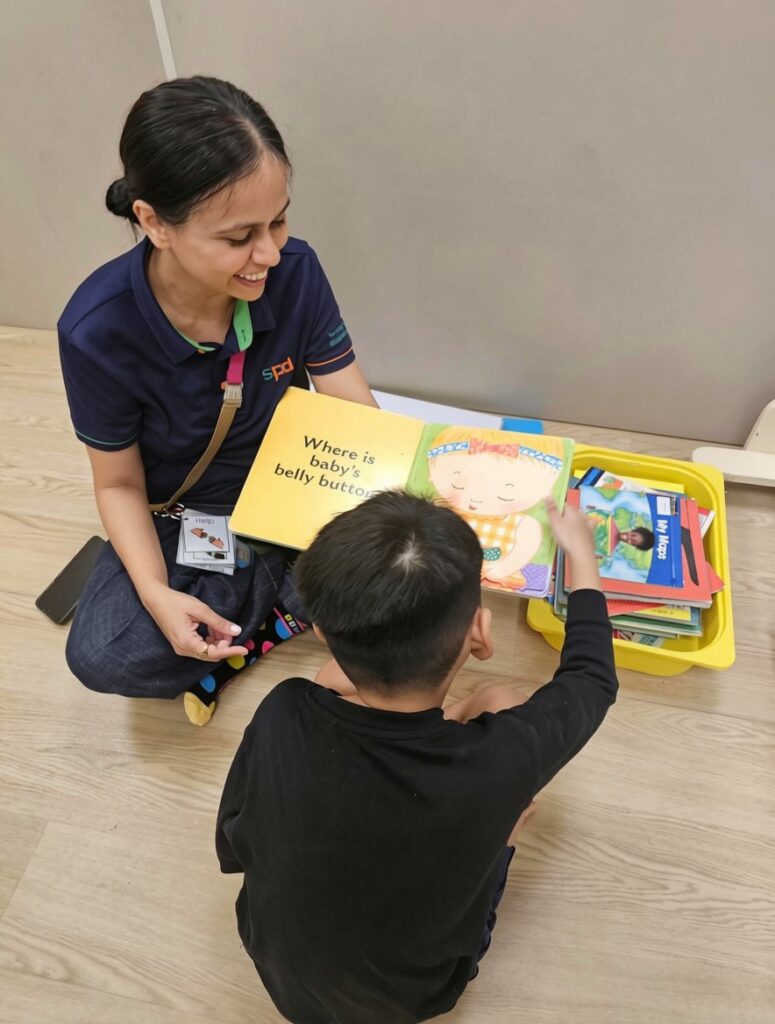 Where Purpose Found Me: Neha Parikh's journey from volunteer to teacher-aide 1 Teacher aide Neha reading a storybook with a young boy