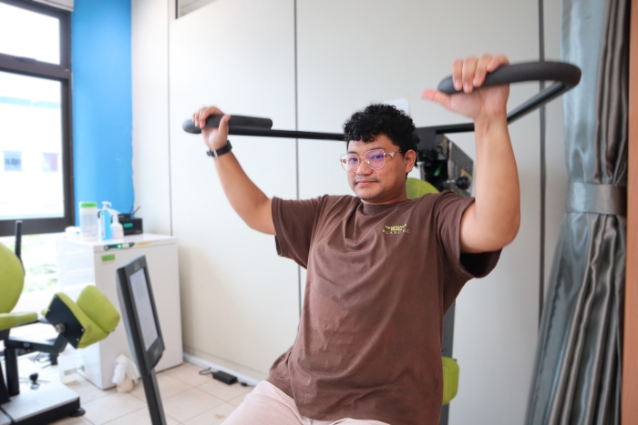 Azhar at the S P D Rehabilitation Centre, using one of the equipment for strength training